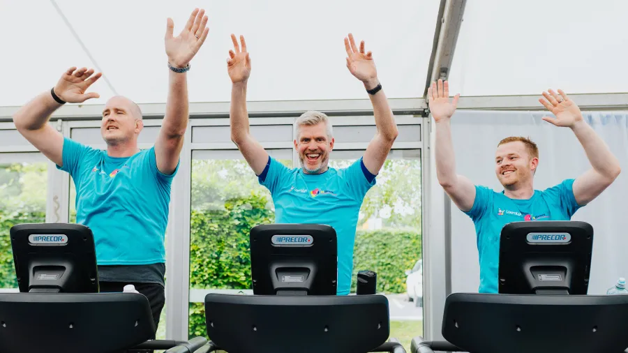 three men in blue lauralynn tshirts running on treadmills