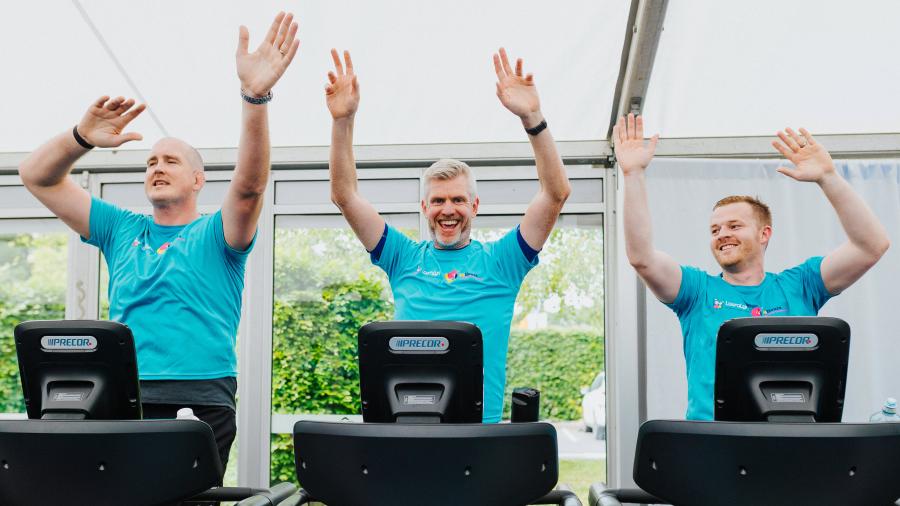 three men in blue lauralynn tshirts running on treadmills