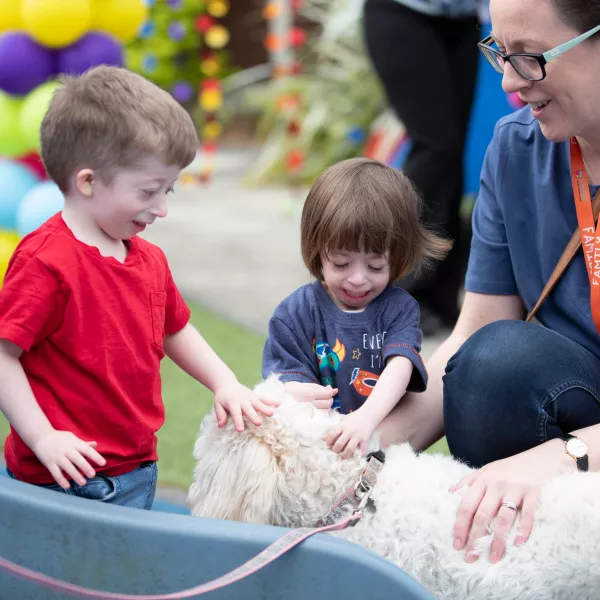 Joshua and Olivia making friends with Jesse the dog in LauraLynn 