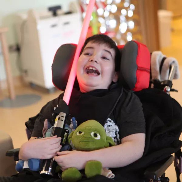 Eoin with his starwars lightsaber in his hand and a big smile on his face 