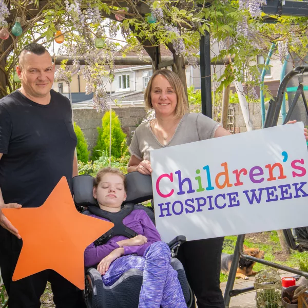 LauraLynn child in wheelchair and her mom and dad 