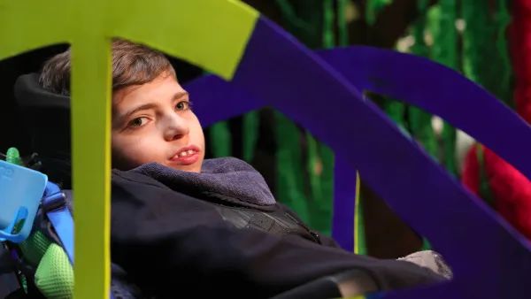 Harry Hoare takes a joyful ride in his cardboard car on the Abbey Theatre stage