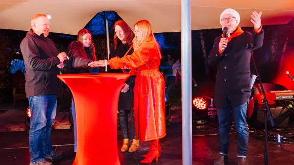 Family and Lyra pushing the button to turn on the lights 