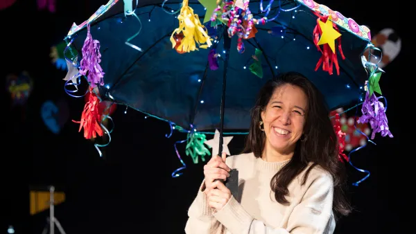 Brina on stage with one of the prop umbrella's 