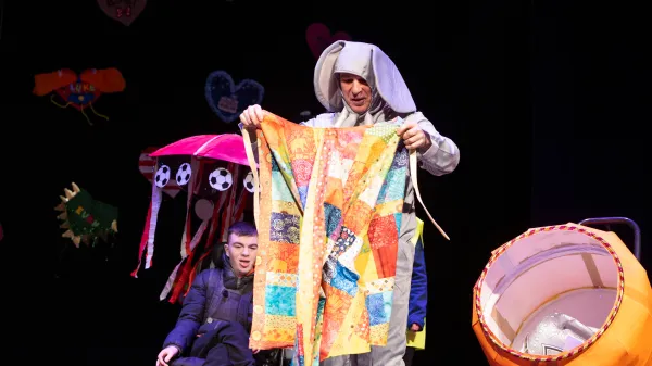 Gerry the elephant on stage with his colourful cloak