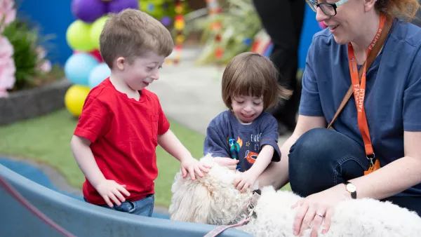 Joshua and Olivia making friends with Jesse the dog in LauraLynn