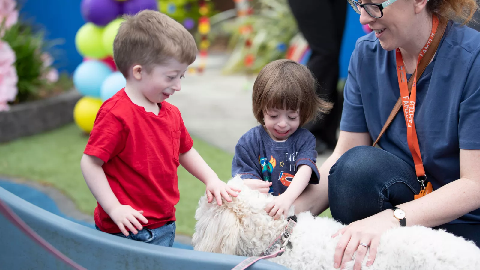 Joshua and Olivia making friends with Jesse the dog in LauraLynn
