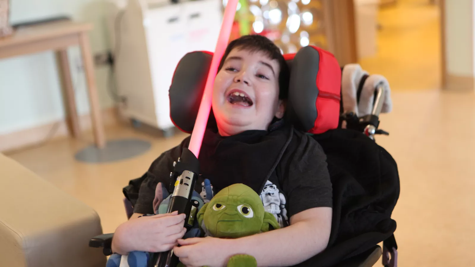 Eoin with his starwars lightsaber in his hand and a big smile on his face